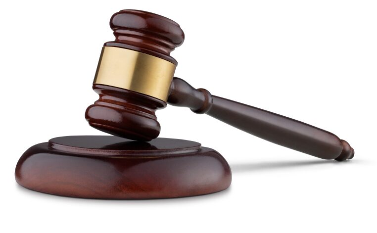Judge's gavel on a wooden block.