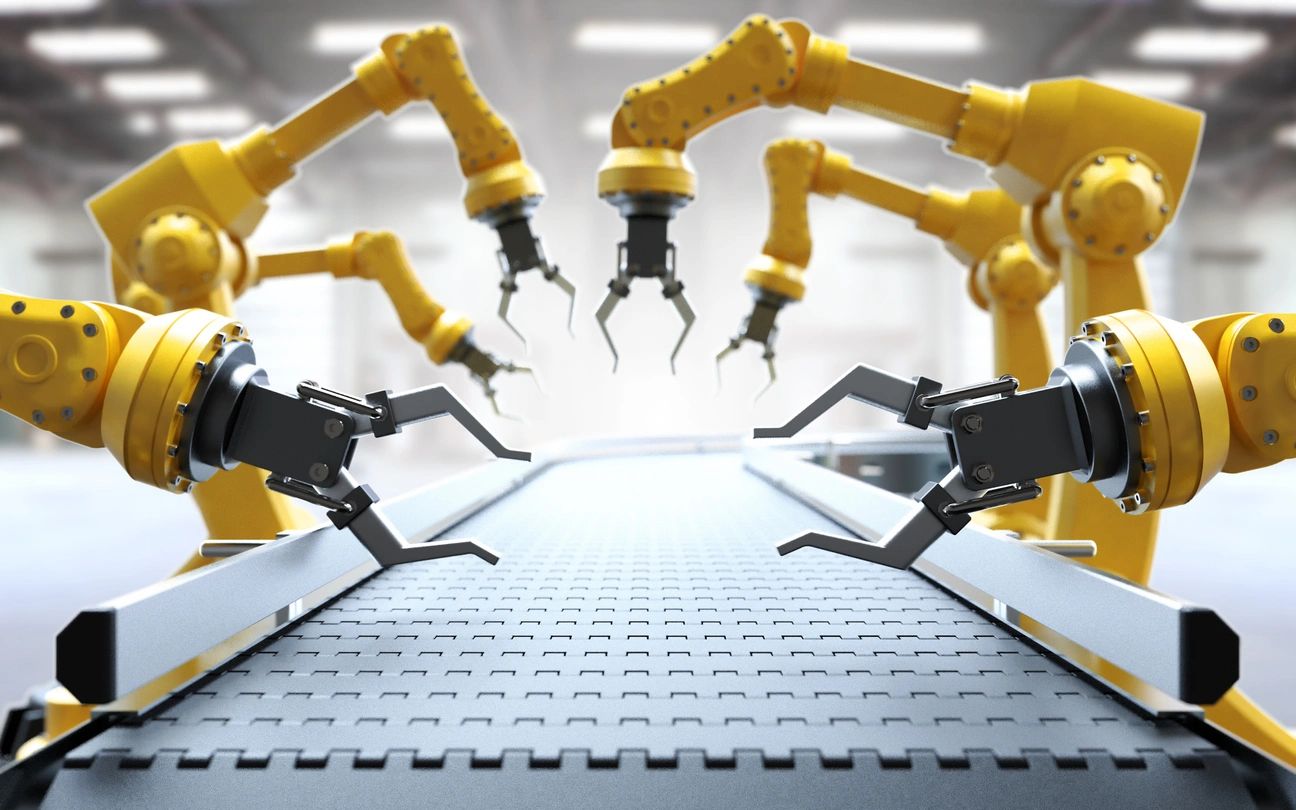 Robotic arms assembling components on a production line.