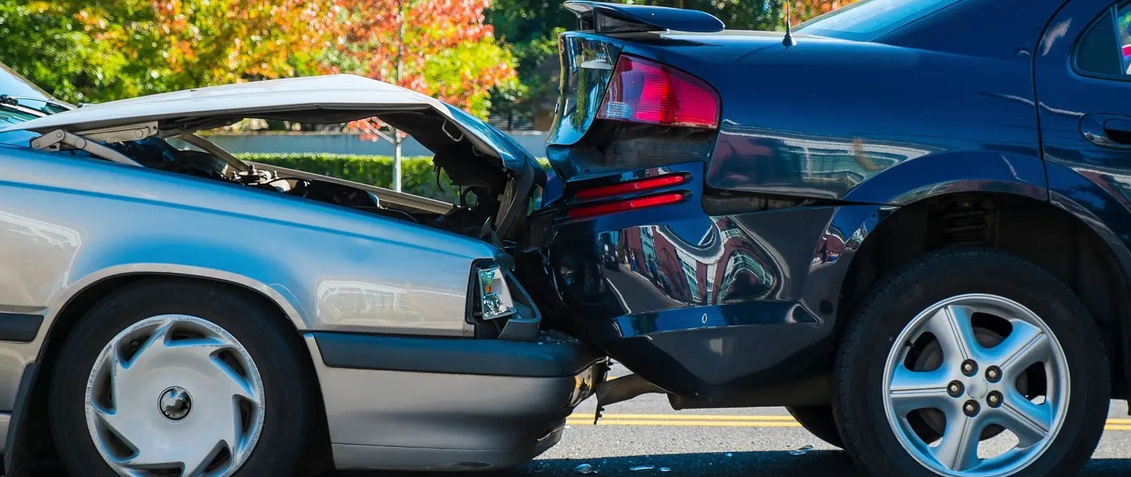 Rear-end collision between two cars with visible damage.