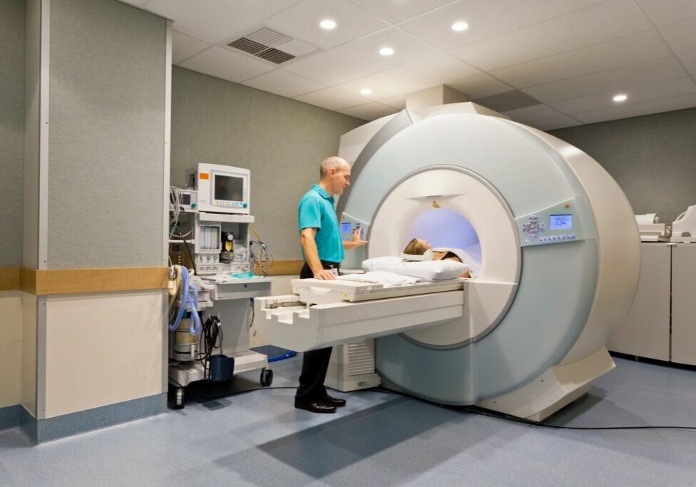 Technician preparing an MRI machine in a medical facility.